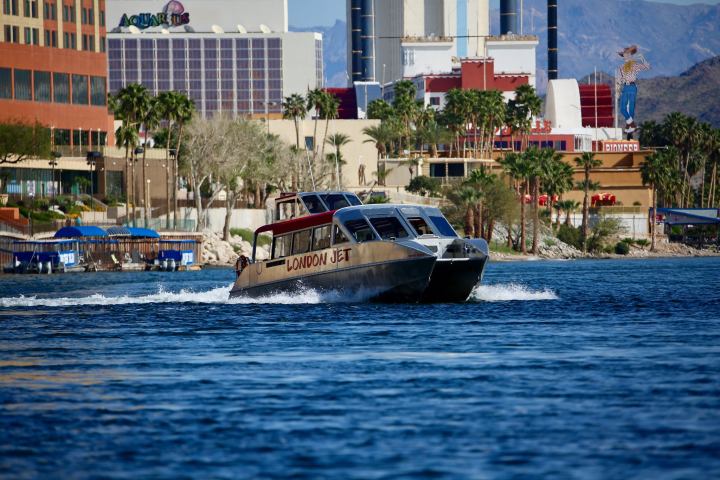 a small boat in a body of water with a city in the background