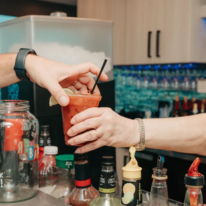 a hand holding a bottle of wine