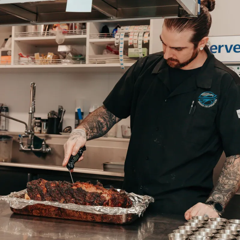 a man standing in a kitchen preparing food