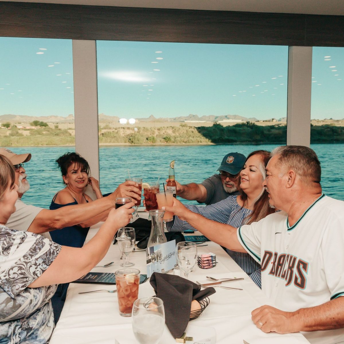 a group of people standing next to a body of water