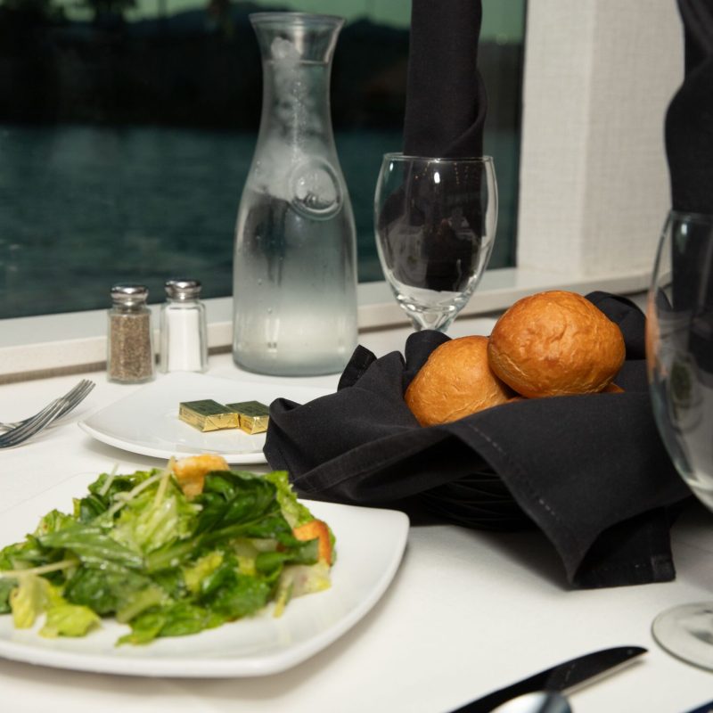 a plate of food and glasses of wine on a table