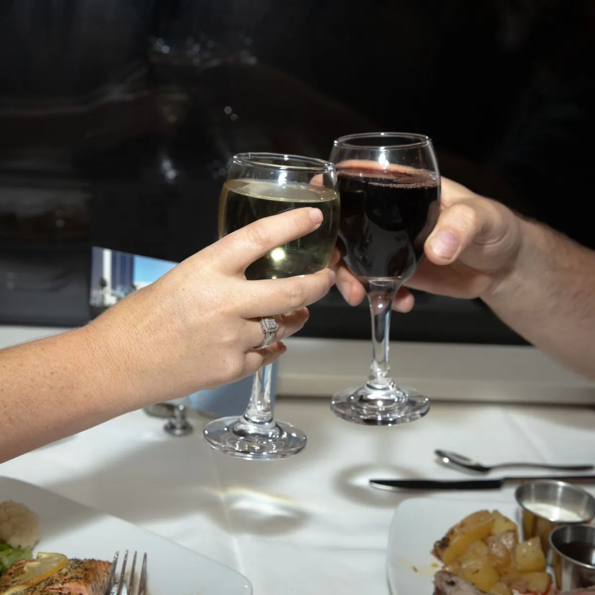a hand holding a glass of wine