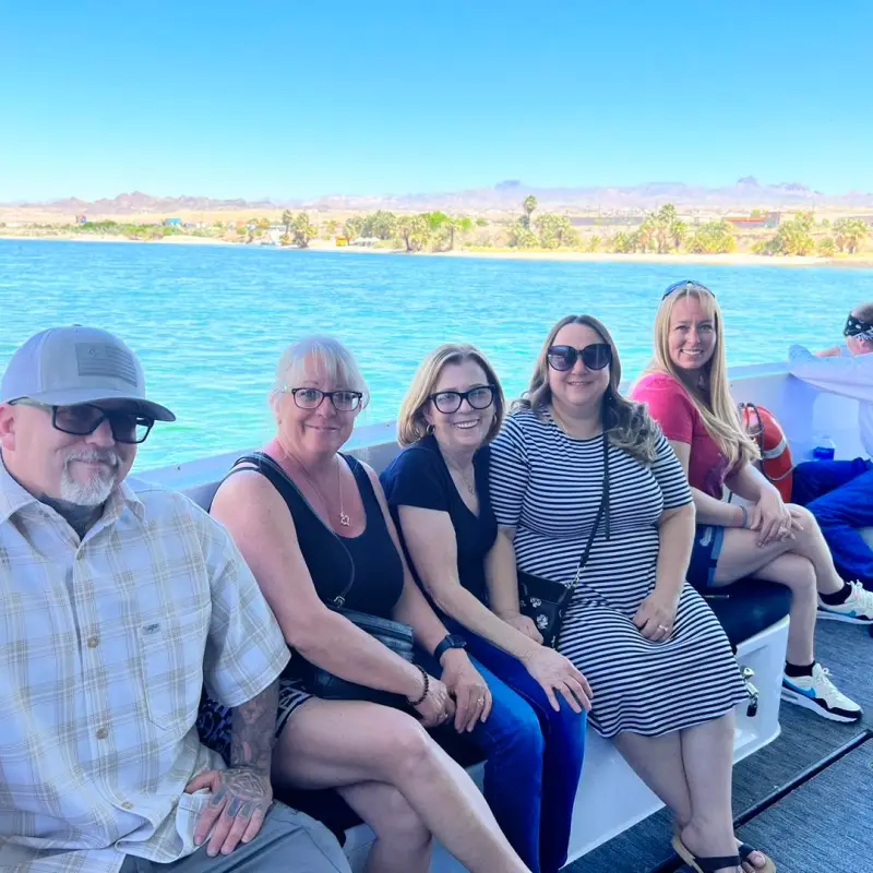 Maria Ramos et al. sitting on a bench next to a body of water
