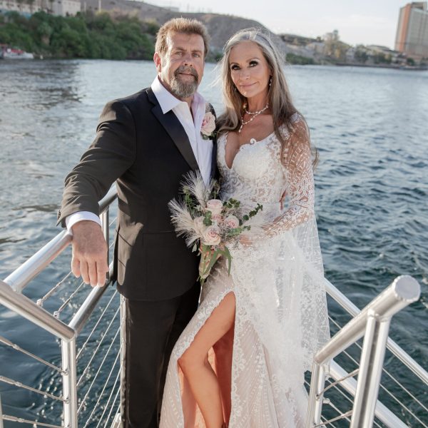 a woman standing next to a body of water