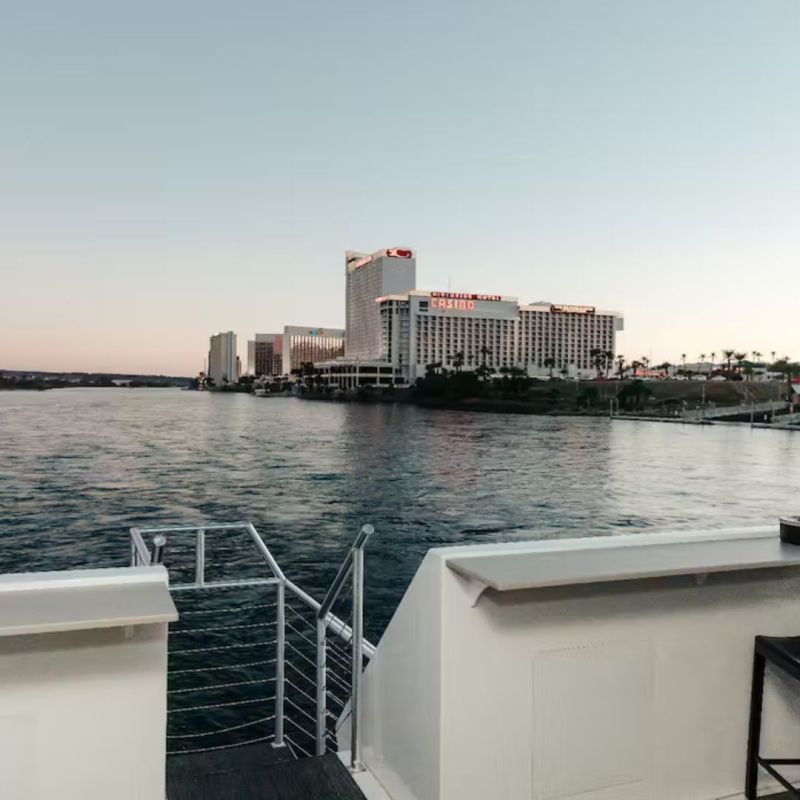 a small boat in a body of water with a city in the background