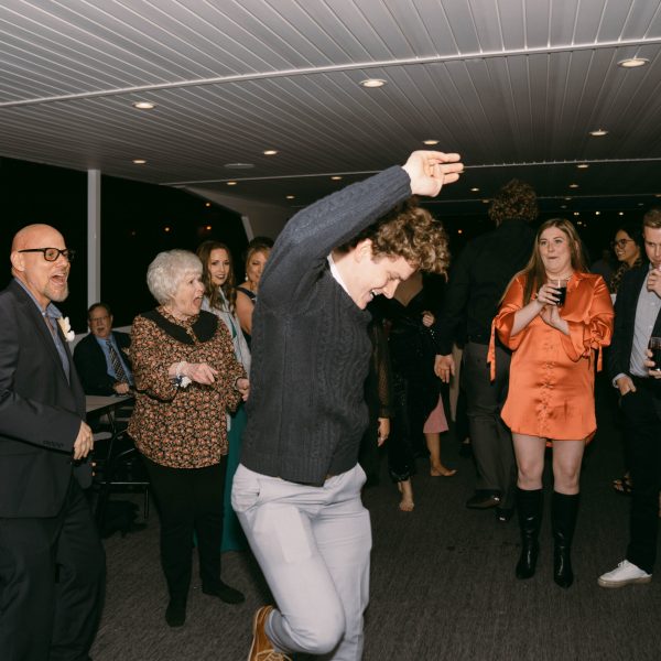 a group of people standing in front of a crowd posing for the camera