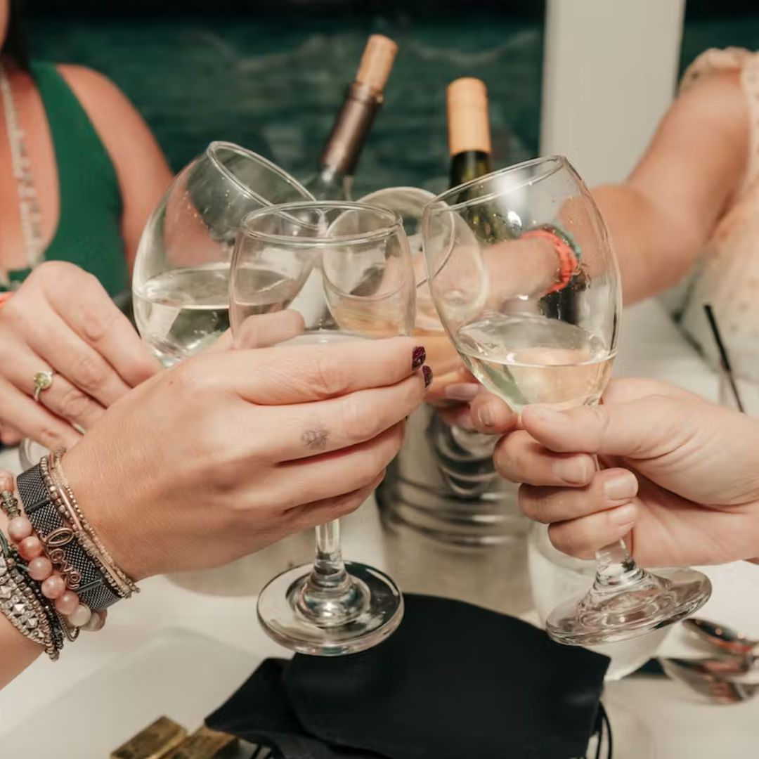 people cheers-ing wine glasses