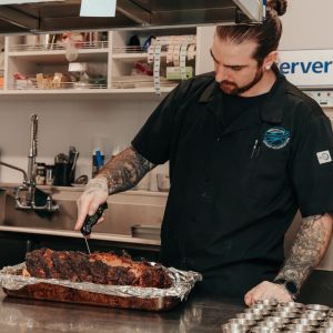 a person taking the temperature of cooked meat