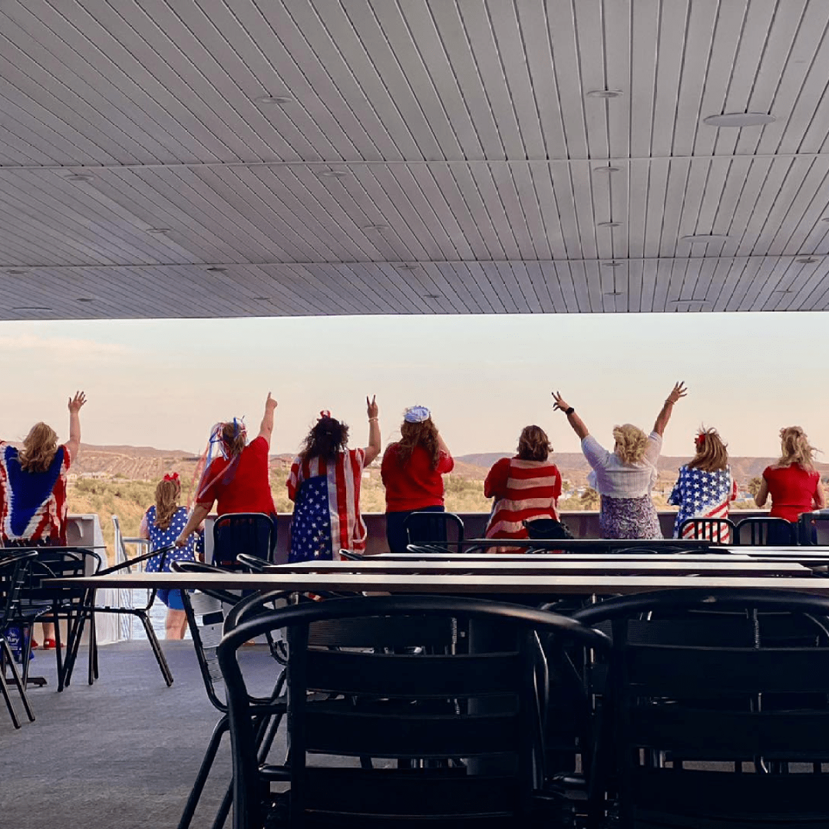 a group of people standing around a table