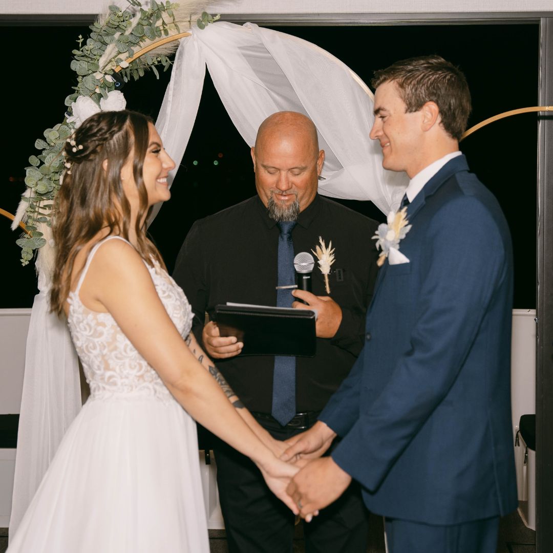 a couple of people that are cutting a wedding cake