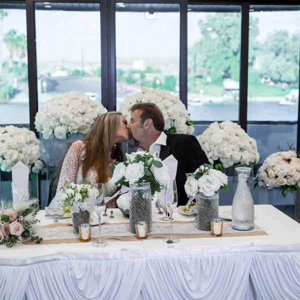 a man and a woman sitting at a table in front of a window