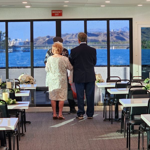 a group of people sitting at a table in front of a window