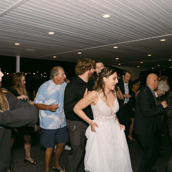 a group of people standing in front of a crowd posing for the camera