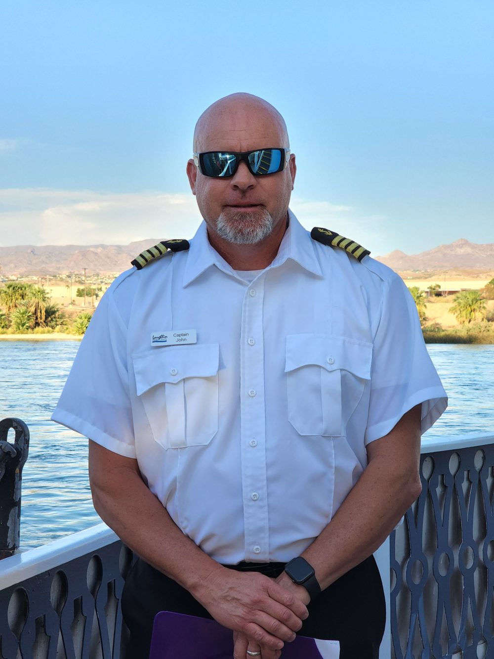 a man standing next to a body of water