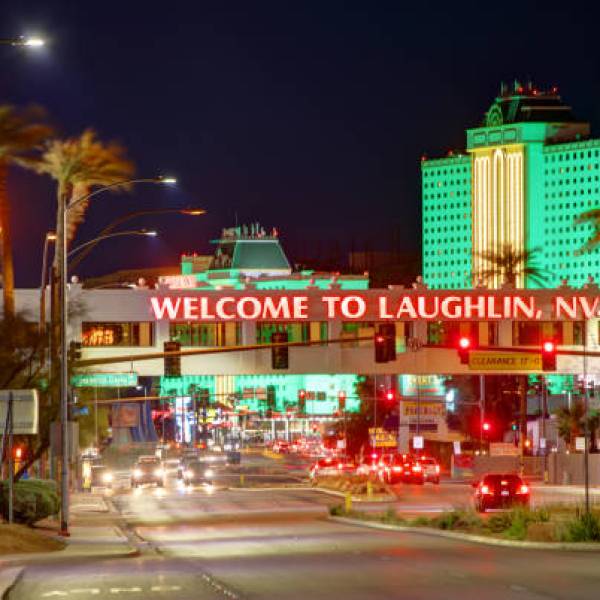 Night view of Laughlin, NV sign with lit buildings and traffic.